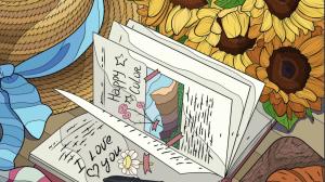 Table with an open journal with writing and drawings, a pen, sunflowers, and a straw sunhat