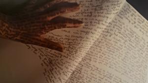 words flowing out of hand on paper.